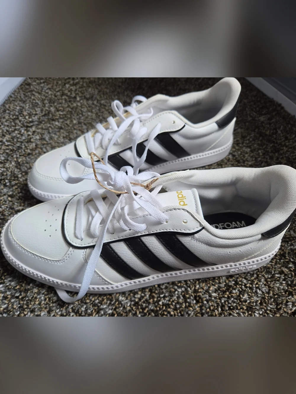 adidas Women’s White Sneakers with Black Stripes and Gold Accents